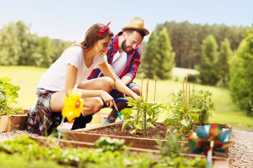 Gardener carrying out routine garden maintenance